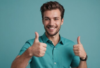 Wall Mural - A happy man with a bright smile gives two thumbs-up in a teal shirt, radiating joy and positivity.