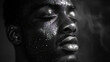 African Man with Closed Eyes: A Black and White Image of a Man Expressing Emotion