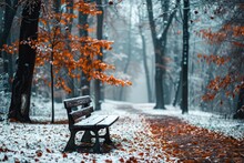 Snow-covered Park Bench Under A Canopy Of Fiery Orange Leaves In A Misty, Serene Winter Forest