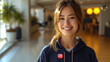 Smiling and confident female office associate - close-up shot - open office - profile shot - open office - bright space - wearing a “VOTED” sticker - election - politics  vote - presidential - polls 