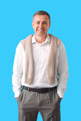 Wall Mural - Mature man in shirt on blue background