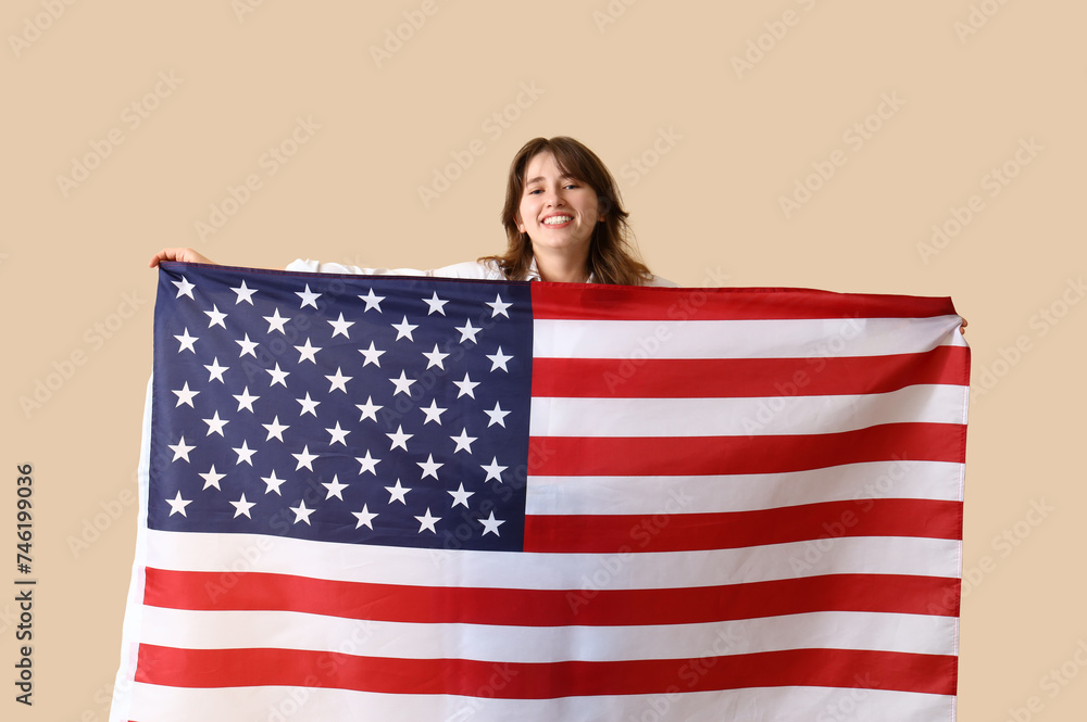 Young woman with USA flag on beige background