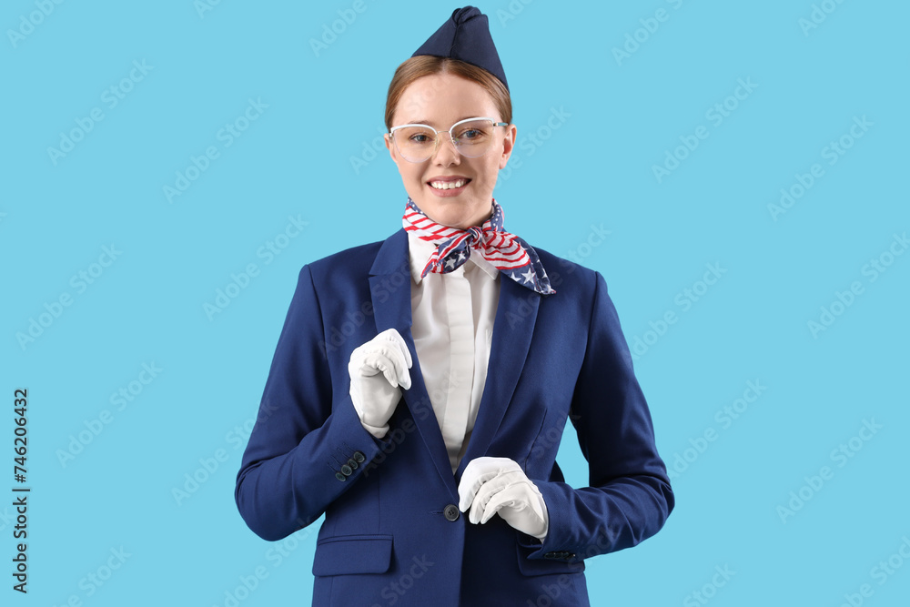 Young stewardess on blue background