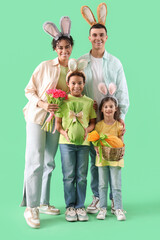 Sticker - Happy family in bunny ears with Easter gift eggs and tulips on green background