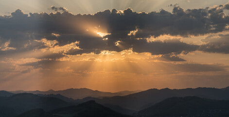 Wall Mural - Picturesque sunrise in the mountains, sun rays	