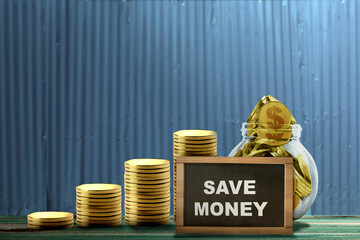 Poster - Stair stack of golden coins and golden coins inside the jar with a small chalkboard with 'save money' text