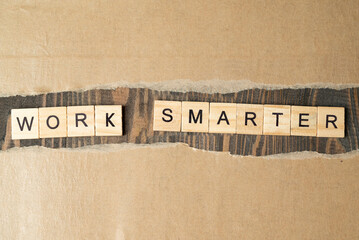 Ripped paper with a row of wooden cubes with 'work smarter' text