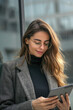 © Emanuel - A businesswoman utilizing a tablet, embodying Communication Concepts