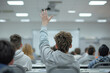 Young student raising his hand in classroom 