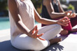© Wavebreak Media - Biracial mother practices yoga by the pool, with copy space