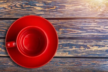 Wall Mural - Red cup for morning coffee on desk background.