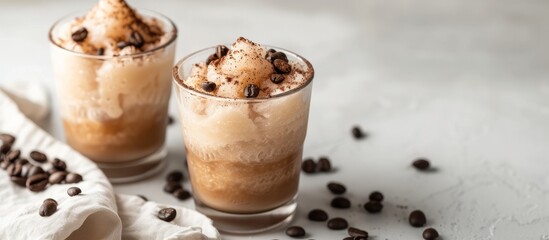 Sticker - Two glasses of iced coffee garnished with coffee beans placed on a table, perfect for a refreshing drink on a hot day.