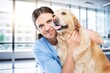 © BillionPhotos.com - Happy vet doctor in uniform with little dog