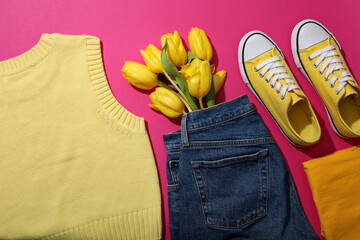 Wall Mural - Female spring outfit and flowers on pink background, top view