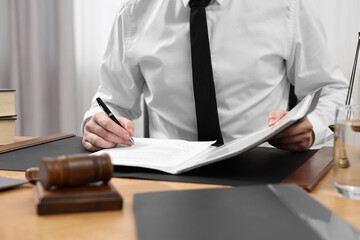 Canvas Print - Lawyer working with documents at table indoors, closeup