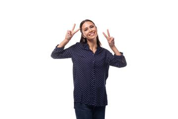 Wall Mural - young European slender brunette woman in blue clothes smiles affably