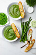 Healthy asparagus, green peas, watercress cream soup with toasted bread and wild garlic, ramson cream cheese