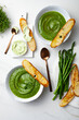 Healthy asparagus, green peas, watercress cream soup with toasted bread and wild garlic, ramson cream cheese