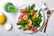 Grilled green asparagus, roasted new baby potatoes, fresh corn salad leaves, soft boiled egg, prosciutto, peas and green herb oil salad.