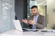 © Liubomir - Professional businessman giving a presentation in modern office setting