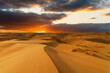 Dramatic sunset over the sand dunes in the desert. Gobi desert