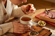 © Rido - Woman add essential oil to her herbal infusion drink