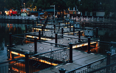 Canvas Print - Black bridge in a city at dusk