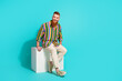 Full length photo of sitting podium platform irish guy macho looking for attractive girlfriend to date isolated on cyan color background
