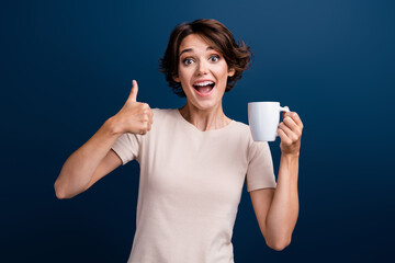 Sticker - Photo portrait of pretty young girl hold coffee mug show okey symbol wear trendy white clothes isolated on dark blue color background