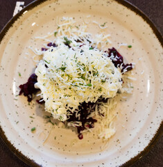 Wall Mural - Mix of beets, cheese, mayonnaise on a plate in restaurant. top view