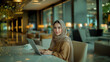 beautiful arab woman on laptop in cafe
