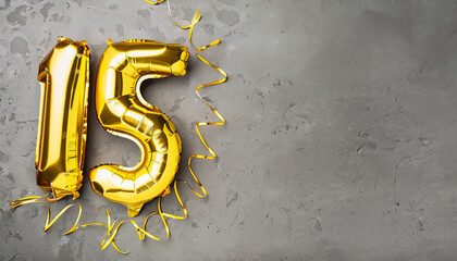 Wall Mural - Yellow foil balloon number, number fifteen on a concrete background. 15th birthday card. Anniversary concept. for anniversary, birthday, new year celebration. banner, copy space.