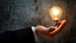 businessman holding a glowing light bulb in hand, innovative business idea concept, creative thinking business innovation, copy space 