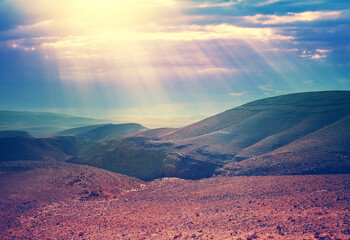 Wall Mural - evening cloudy sky over mountain desert. negev desert in israel at sunset