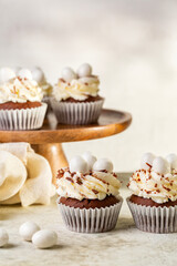 Sticker - Chocolate cupcakes with cream cheese, sweet candy eggs shaped. Holiday homemade dessert. Copy space.