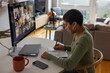 © ReeldealHD images - Young adult woman on a video conference call with colleagues working from home