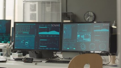 No people shot of cybersecurity officer workplace with two computer monitors with secret network data program on screen and portable radio set on desk