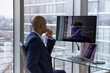 © ReeldealHD images - Stock trader looking at stocks and shares on computer in a high rise office