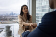 © ReeldealHD images - Businesswoman shaking hands in a corporate meeting with view of London city skyline