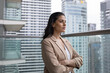 © ReeldealHD images - Businesswoman on office balcony looking confidently at city skyline