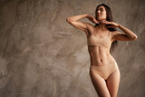 Fototapeta Panele - Photo of stunning lady model sporty shape thin waist posing in beauty studio casual lingerie isolated on grey concrete wall background