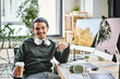© LIGHTFIELD STUDIOS - Relaxed young man with stylus pen and coffee smiling at a startup post-production workspace