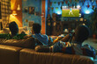 Guys of different nationalities watch soccer on the couch at home and cheer for their team