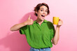 Leinwandbild Motiv Photo portrait of attractive young woman hold coffee mug show thumb up dressed stylish green clothes isolated on pink color background