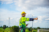 Fototapeta Storczyk - Wind turbine Engineer working in wind turbine farm , Generator station, renewable energy , Sustainable energy industry concept