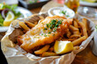 Fish and chips fried in batter served with lemon, traditional England food.