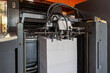 © kanpisut - Printed sheets of paper are served in the printing press. Offset , CMYK. Offset printing machines. Large printing machine perspective.
