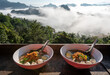 Noodles in a cup with a view of the sea of mist at Jabo village, Mae Hong Son, Thailand