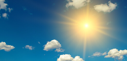 Poster - Bright sun on beautiful blue sky with white clouds.