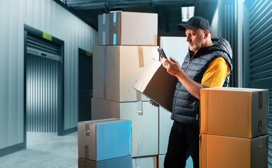 Wall Mural - Business man near storage container. Warehouse for goods. Open storage container near guy. Man in corridor of warehouse company. Storage container near guy with boxes. Unit, space, room